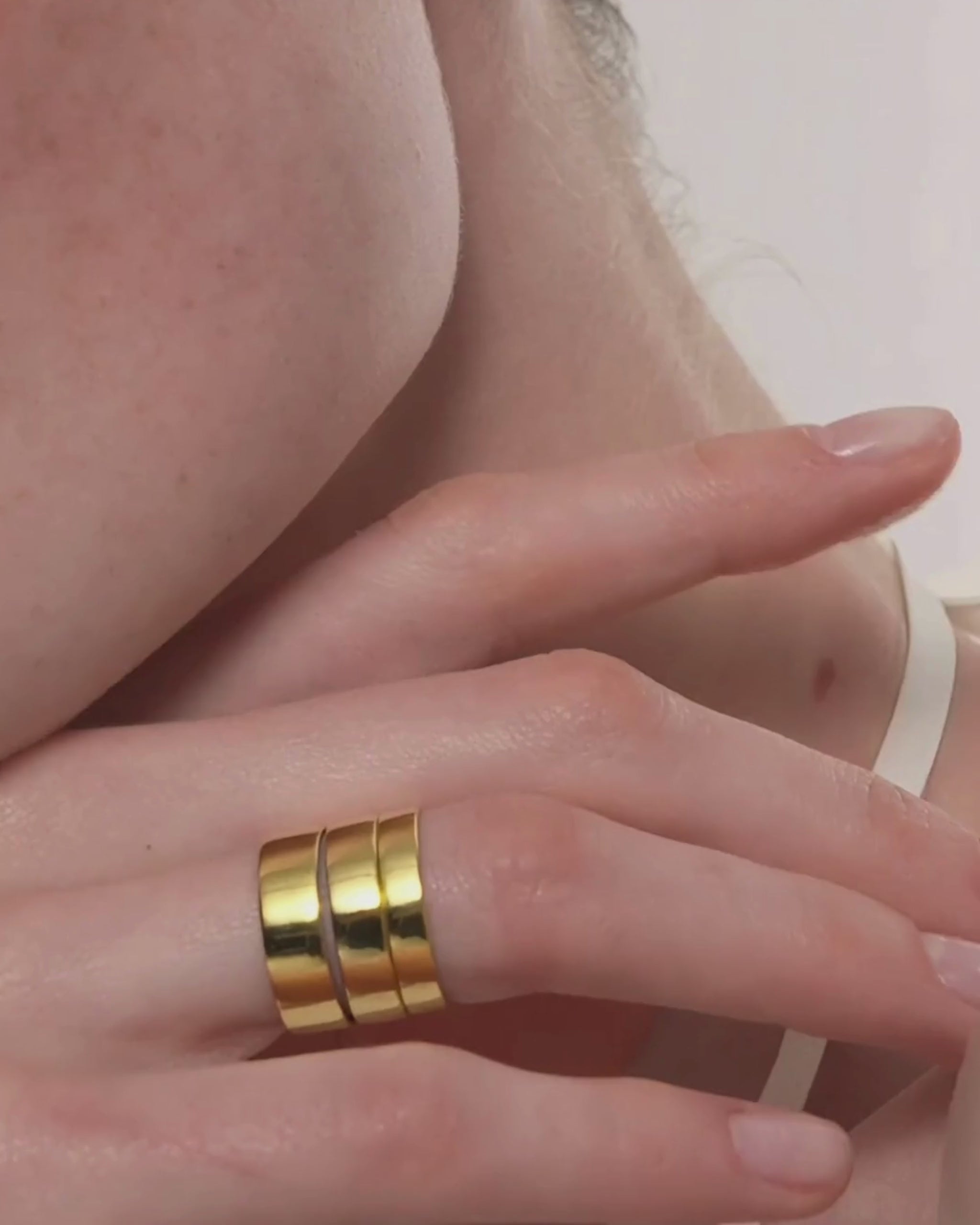 Video showing a woman wearing the Cigar Band Ring by ENEA in six different widths stacked on her fingers
