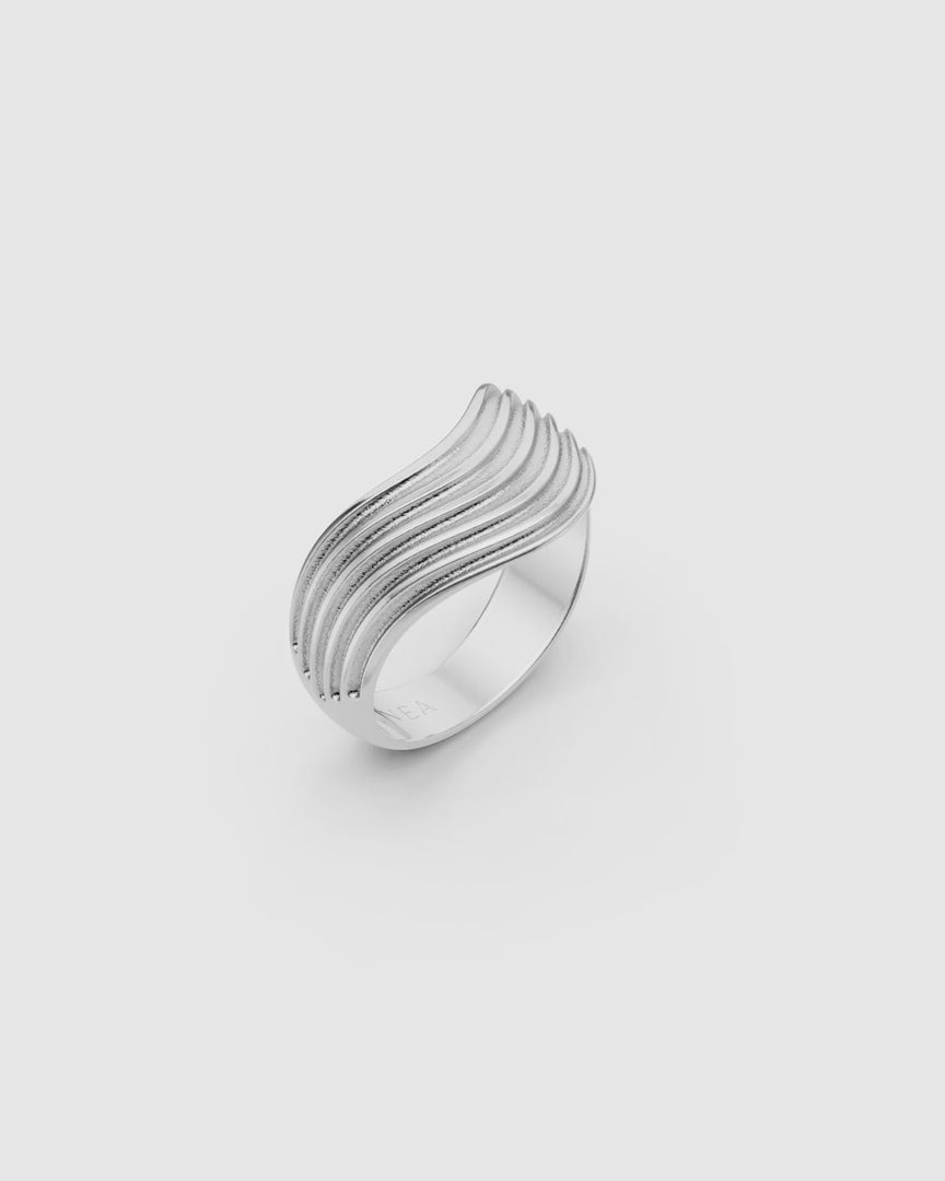 Video giving a 360 view of the Kion III Ribbed Wave Ring in sterling silver on a white surface