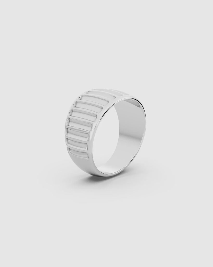 Video giving a 360 view of the Kion Ribbed Dome Ring in sterling silver on a white surface
