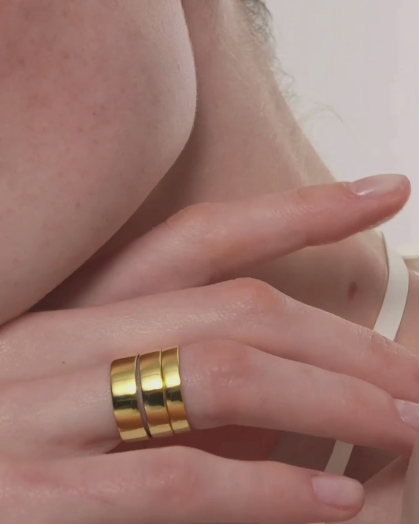 Video showing a woman wearing the Cigar Band Ring by ENEA in six different widths stacked on her fingers