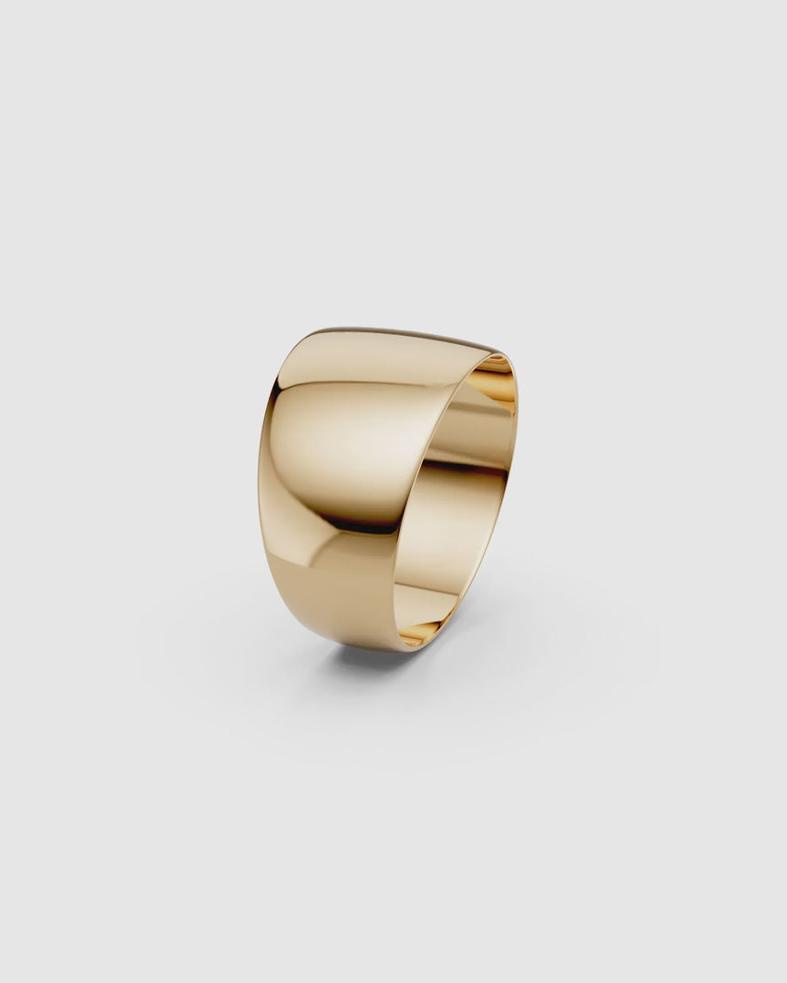 Video giving a 360 view of the Kion Classic Dome Ring in yellow gold on a white surface
