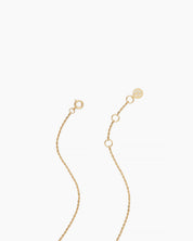 Close view of the solid yellow gold extender chain and clasp