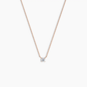 Delicate rose gold necklace featuring a single round-cut solitaire diamond pendant, displayed on a clean white background.
