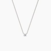 Minimalist white gold solitaire diamond necklace with a round-cut diamond on a delicate chain, shown on a clean white background.
