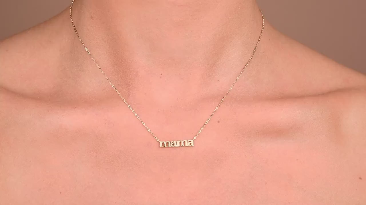 Solid gold mama necklace on a model d